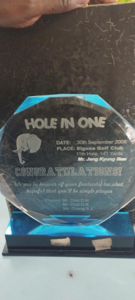 Custom engraved Hole-in-One golf award with a clear octagonal plaque and blue base in Nairobi, Kenya