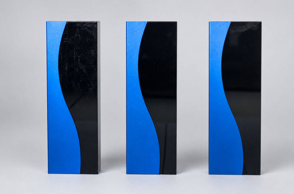 Three CR012 rectangular crystal awards with blue curved panels and black faces