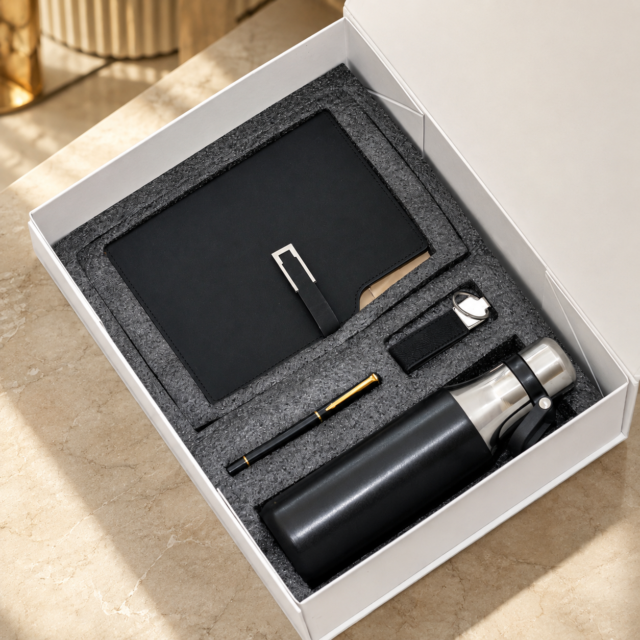Notebook, pen and flask in a presentation box