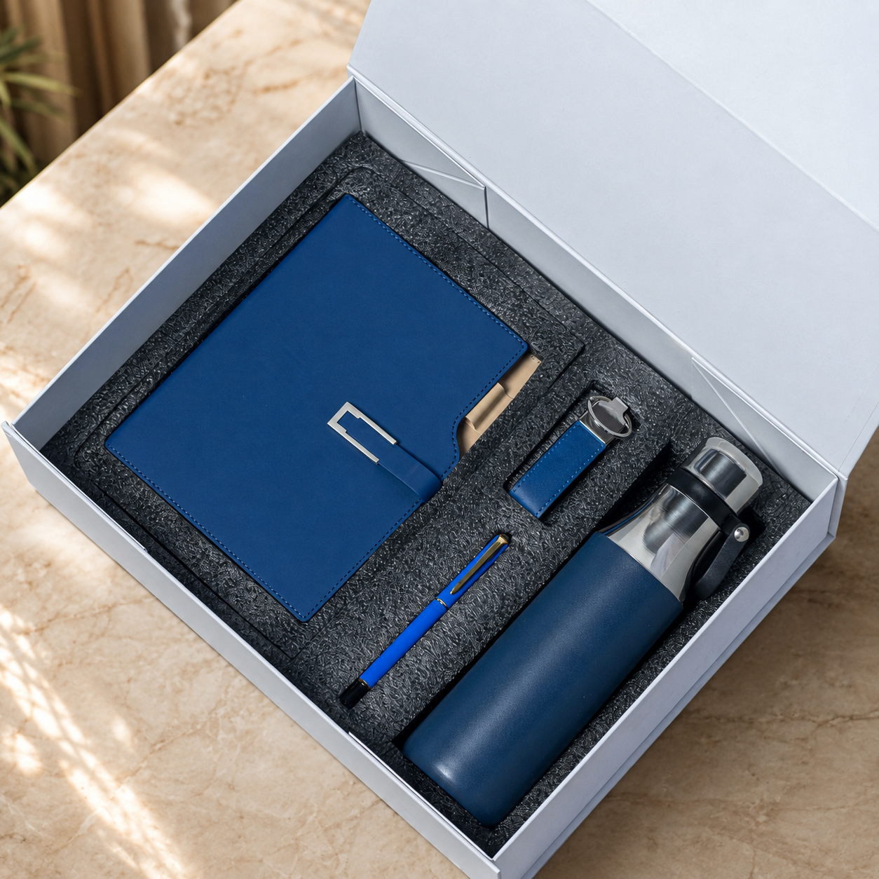 Notebook, pen and flask in a presentation box