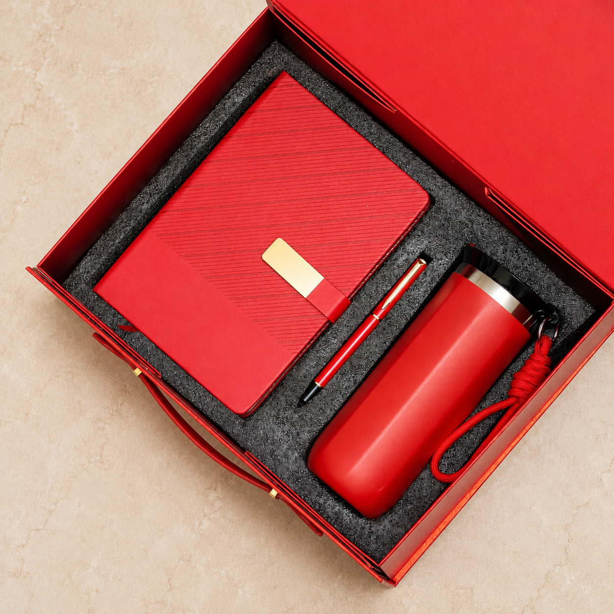Wave-pattern notebook, pen and flask in a presentation box