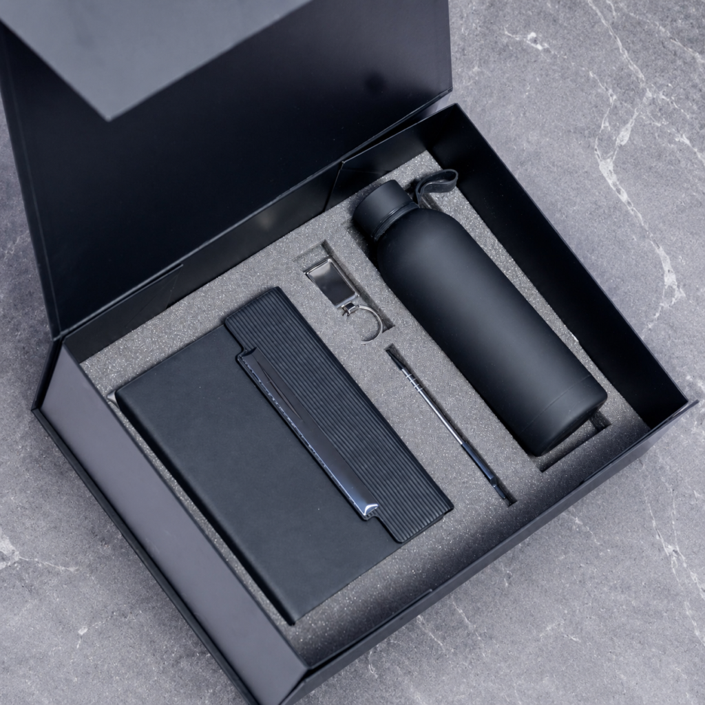 Notebook, pen and bottle arranged in a gift box