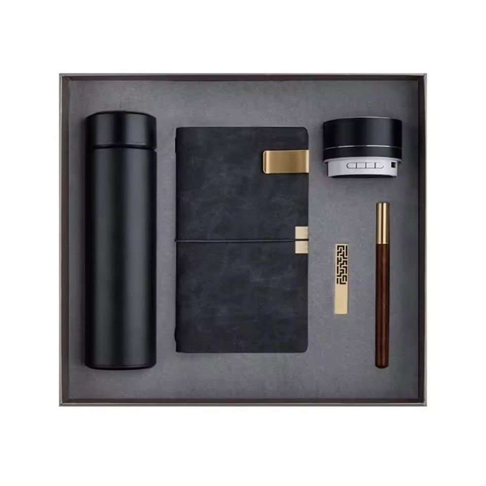 Black bottle, A6 notebook, wooden pen, USB drive, bookmark and Bluetooth speaker in a presentation box