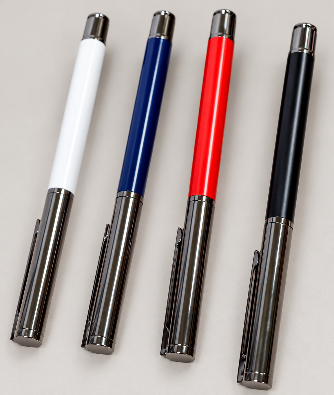 White, blue, red and black executive pens with dark gunmetal trim on a neutral studio background